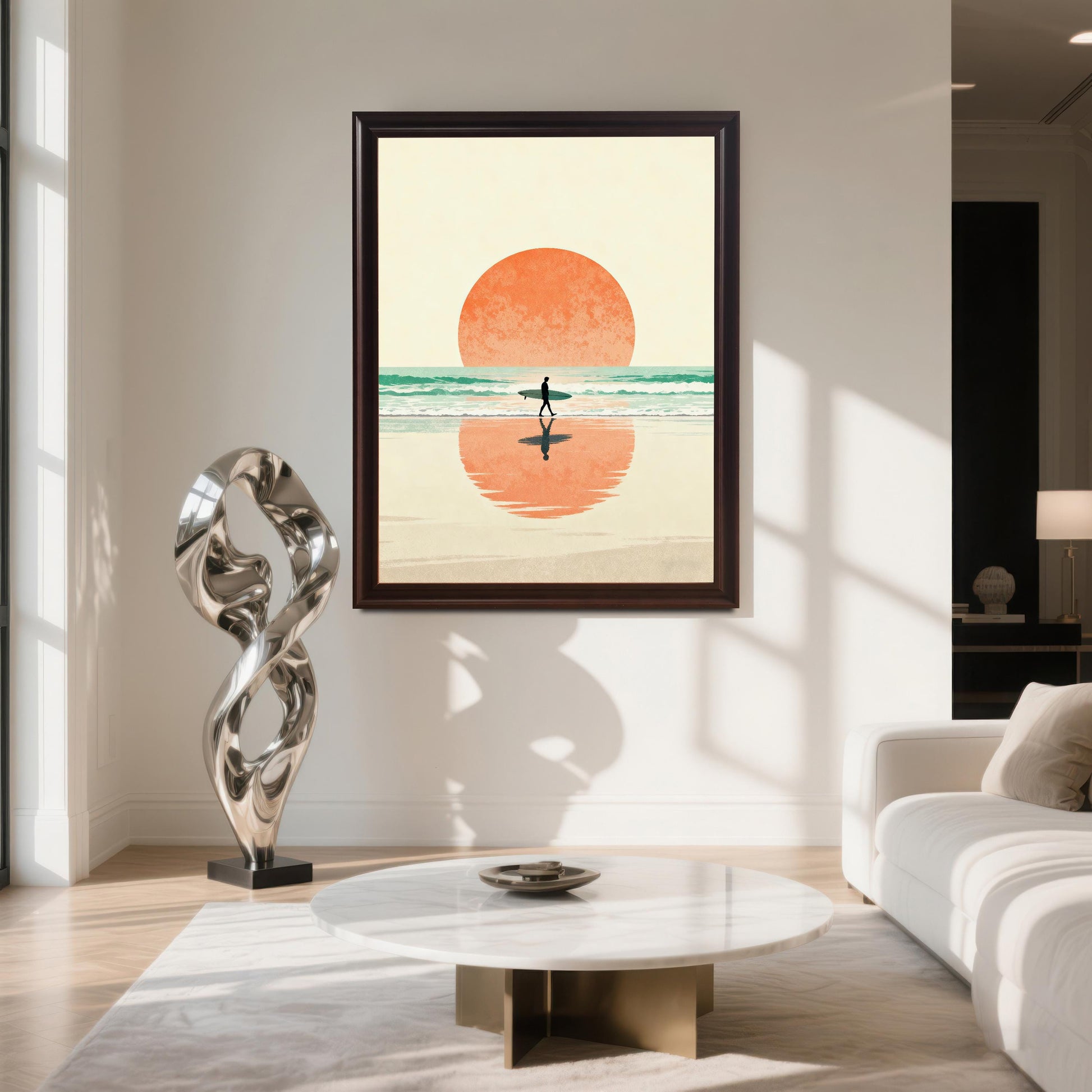 Vertical art print of a minimalist surfer walking into the sunset, with the large orange sun reflected in the wet sand, framed in Coffee (dark brown) with No Mount. The art is hung on a white wall in a luxurious, sunlit living room with a white marble coffee table and a large, modern silver sculpture.