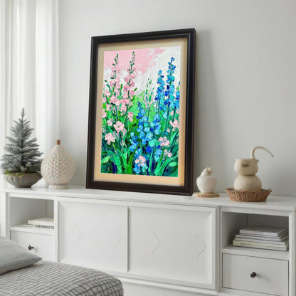 Styled photo of the floral art print in a Dark/Coffee frame with a mount, displayed on a white console table in a bedroom setting next to small decorative objects and a small Christmas tree.