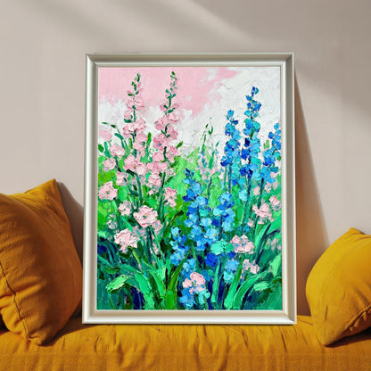 Styled photo of the floral art print in a White frame, resting on a bright yellow couch or cushions.