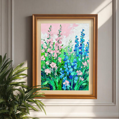 Styled photo of the floral art print in a Brown wood frame, hanging on a light gray panel wall, next to a large potted palm plant.