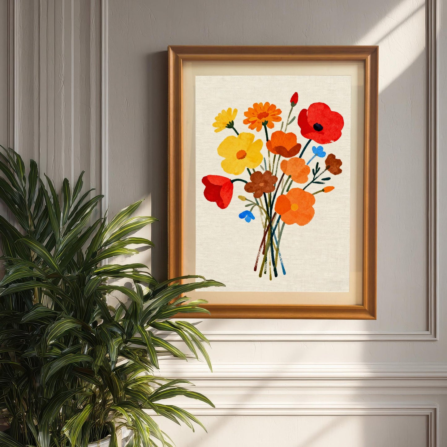 Styled photo of the floral bouquet art print in an Orange/Brown wood frame with a mount, hanging on a light gray panel wall, next to a large potted palm plant.