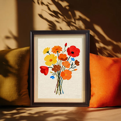 Styled photo of the Modern Floral Bouquet art print in a Dark/Coffee frame, leaning against a wall between two large orange and yellow-green cushions, emphasizing warm tones and sunlight shadows.