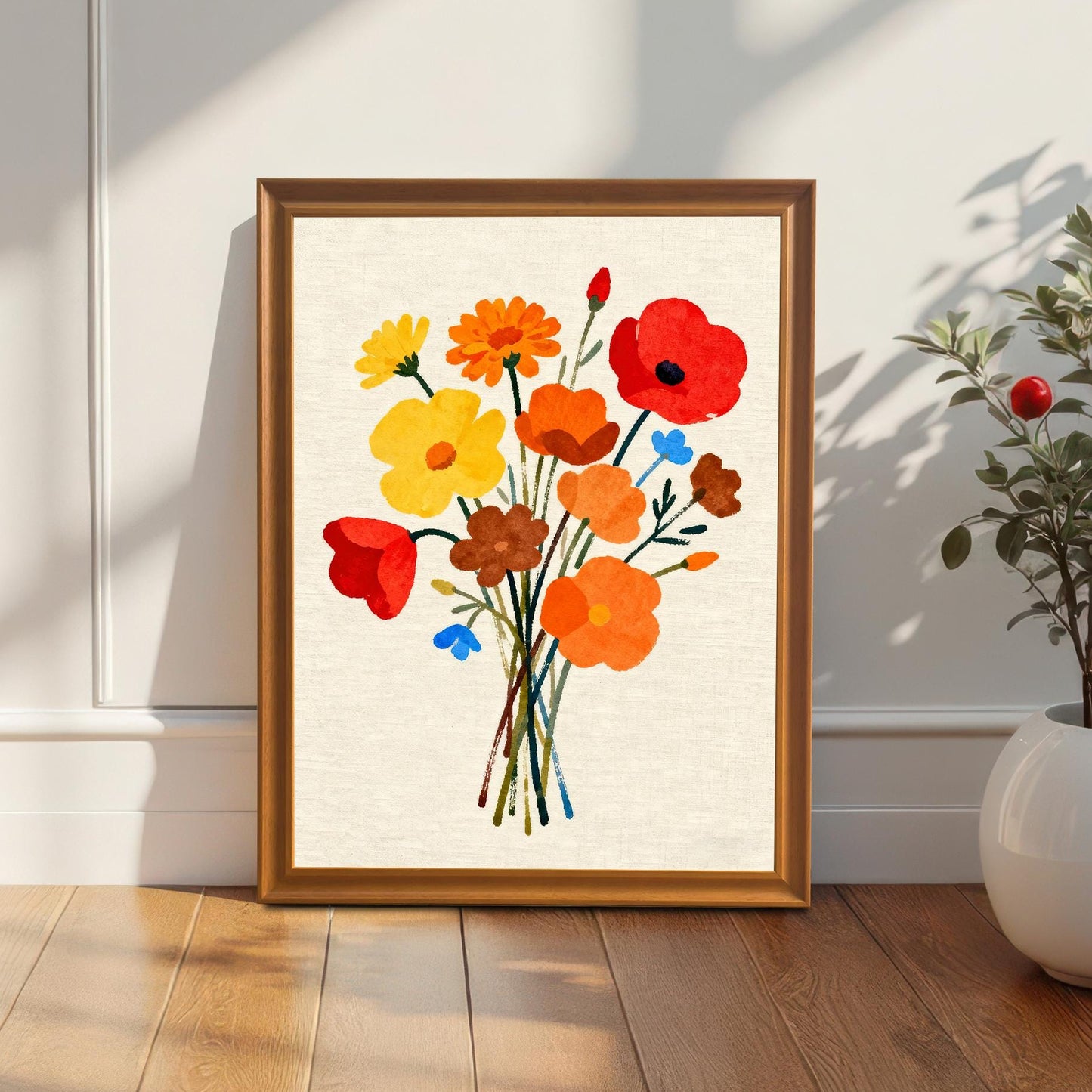 Styled photo of the floral bouquet art print in an Orange/Brown wood frame, leaning against a white wall next to a houseplant, illuminated by natural light.