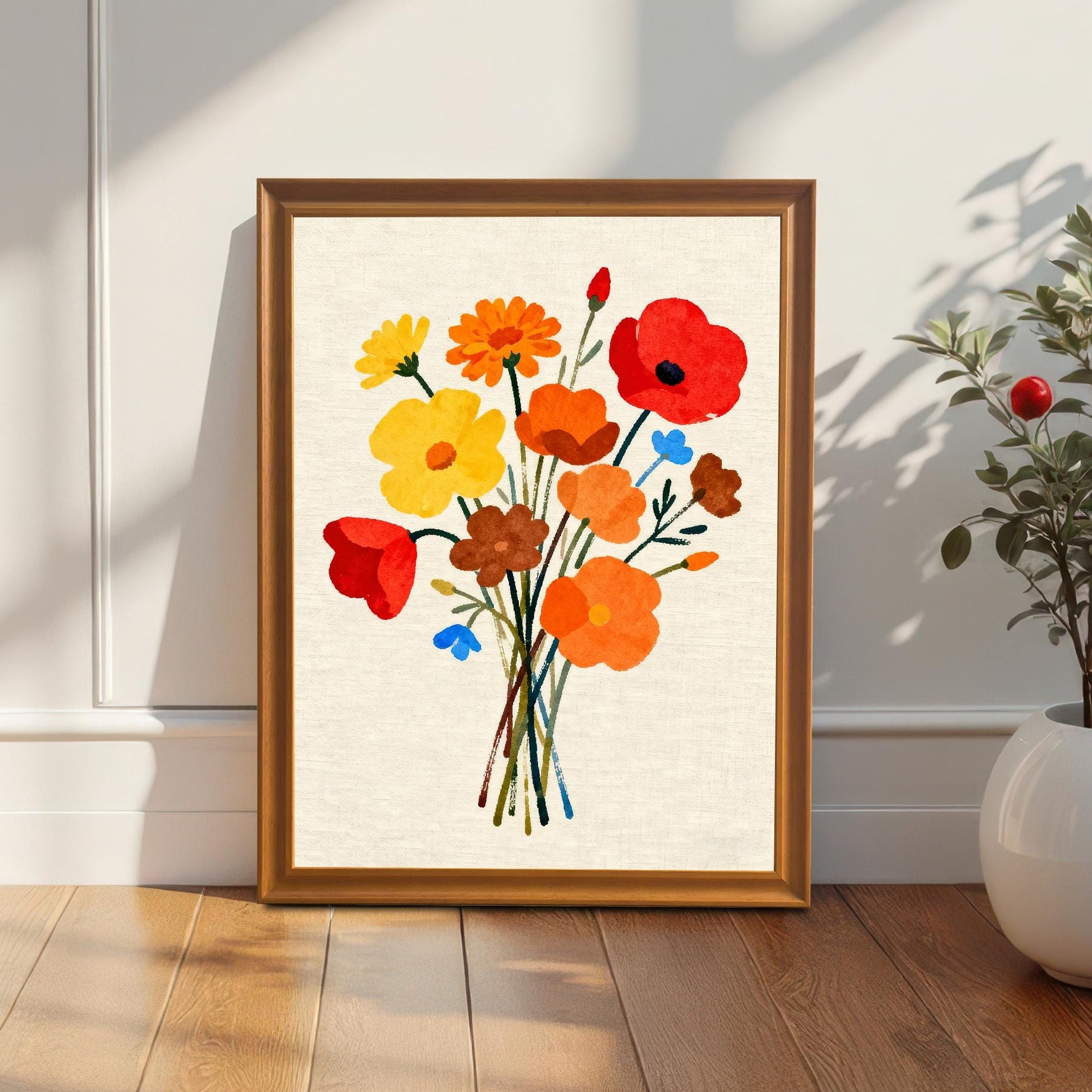 Styled photo of the floral bouquet art print in an Orange/Brown wood frame, leaning against a white wall next to a houseplant, illuminated by natural light.