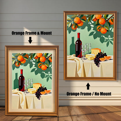 Modern still life art print featuring a wine bottle, glasses, cheese, grapes, and oranges. Shown in two framed options: an Orange Frame with a Mount (lighter border/mat) on the left, and an Orange Frame with No Mount on the right.