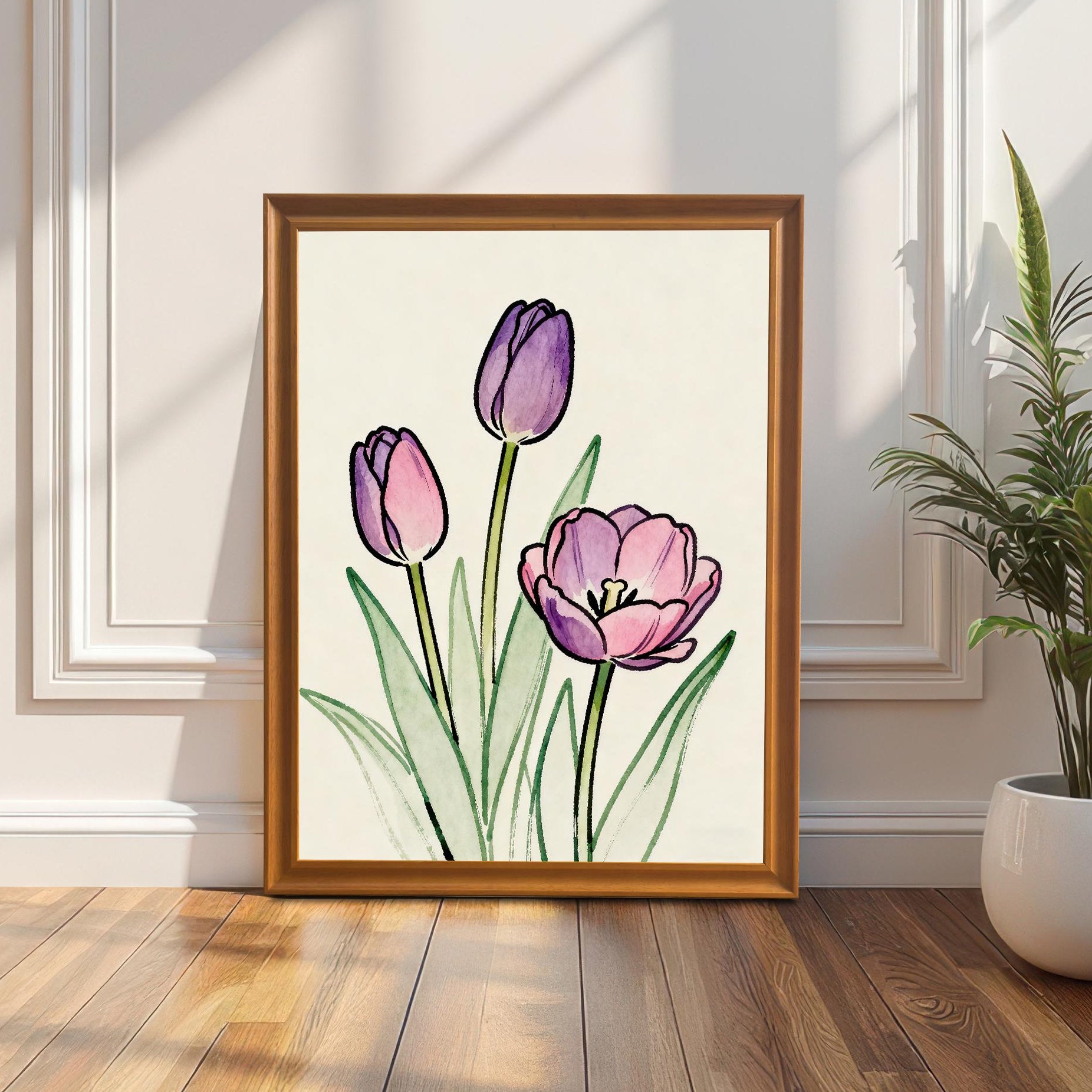 Lifestyle photo showing the framed tulip art print leaning on a wooden floor against a decorative white wall, next to a tall potted plant. The frame is a natural wood color (Orange color option).