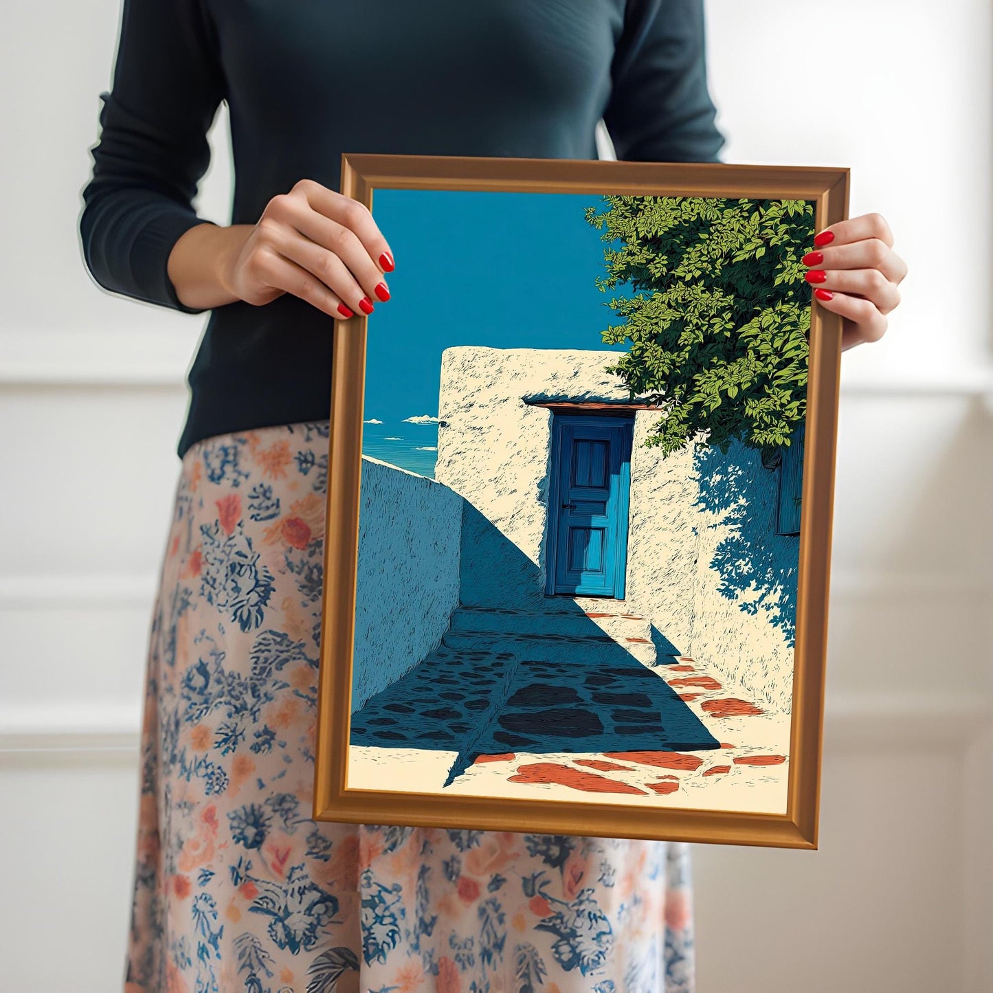 A woman in a dark shirt and floral skirt holding the framed art print in an Orange Frame with both hands, showcasing the print's composition and scale.