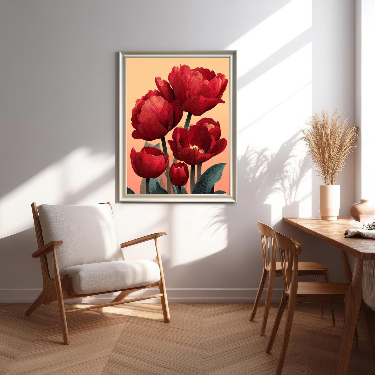 A framed print of the red tulip art in a White/Silver frame hanging on a wall in a bright, modern living space next to a white wooden armchair and dining area.