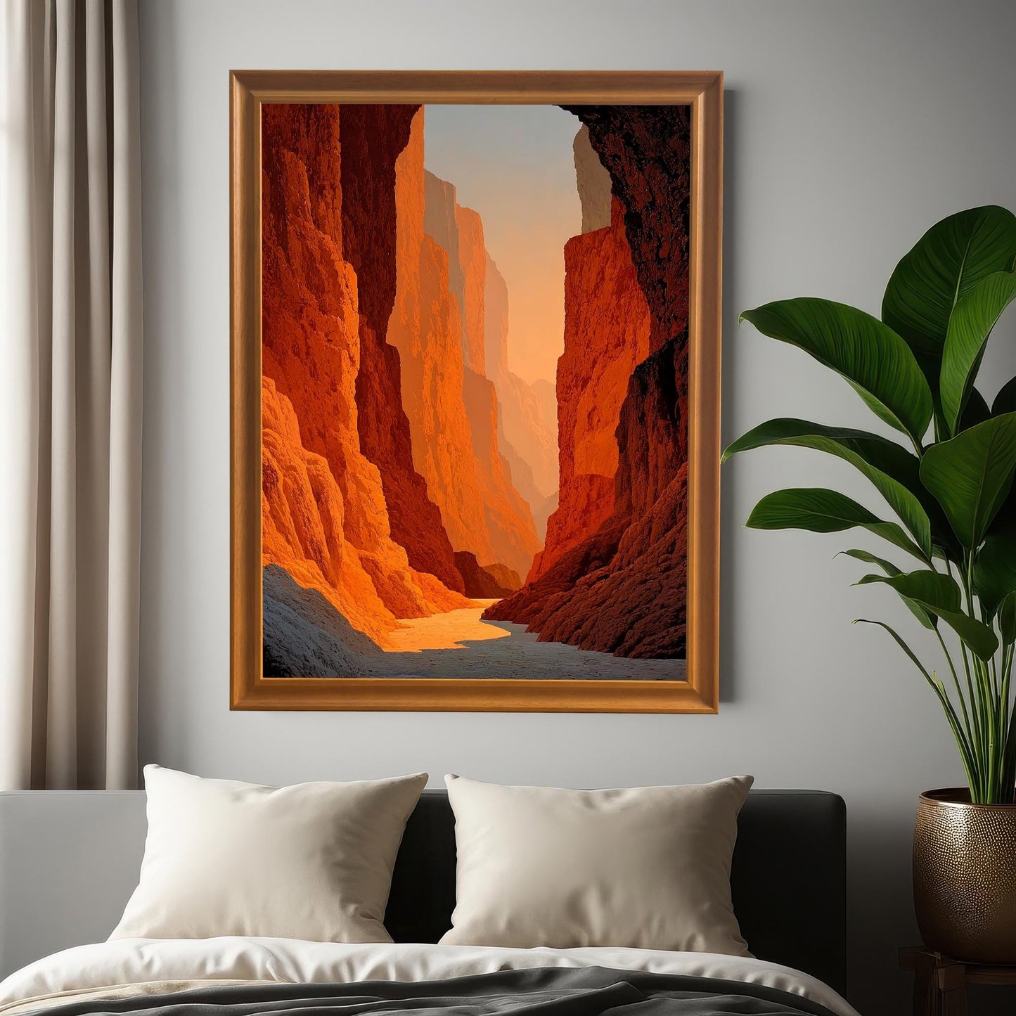 Photo of the framed canyon art print (Orange frame, no mount) hung on a gray wall above a bed, next to a window and a large potted plant, showing the art in a bedroom setting.