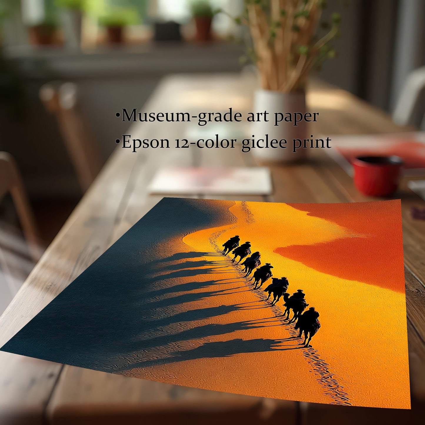 Close-up of the desert caravan art print resting on a wooden table. Text highlights product quality: Museum-grade art paper and Epson 12-color giclee print.