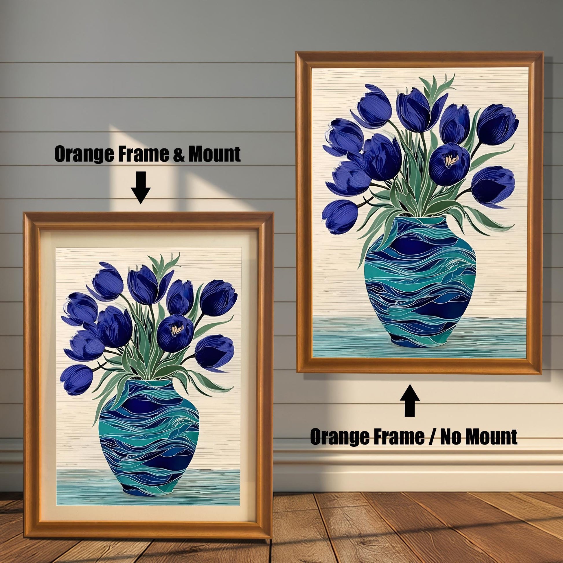 Two framed prints of the blue tulips in a turquoise vase on a rustic wood-paneled wall and floor. The left shows an Orange Frame & Mount (matting), and the right shows an Orange Frame / No Mount.
