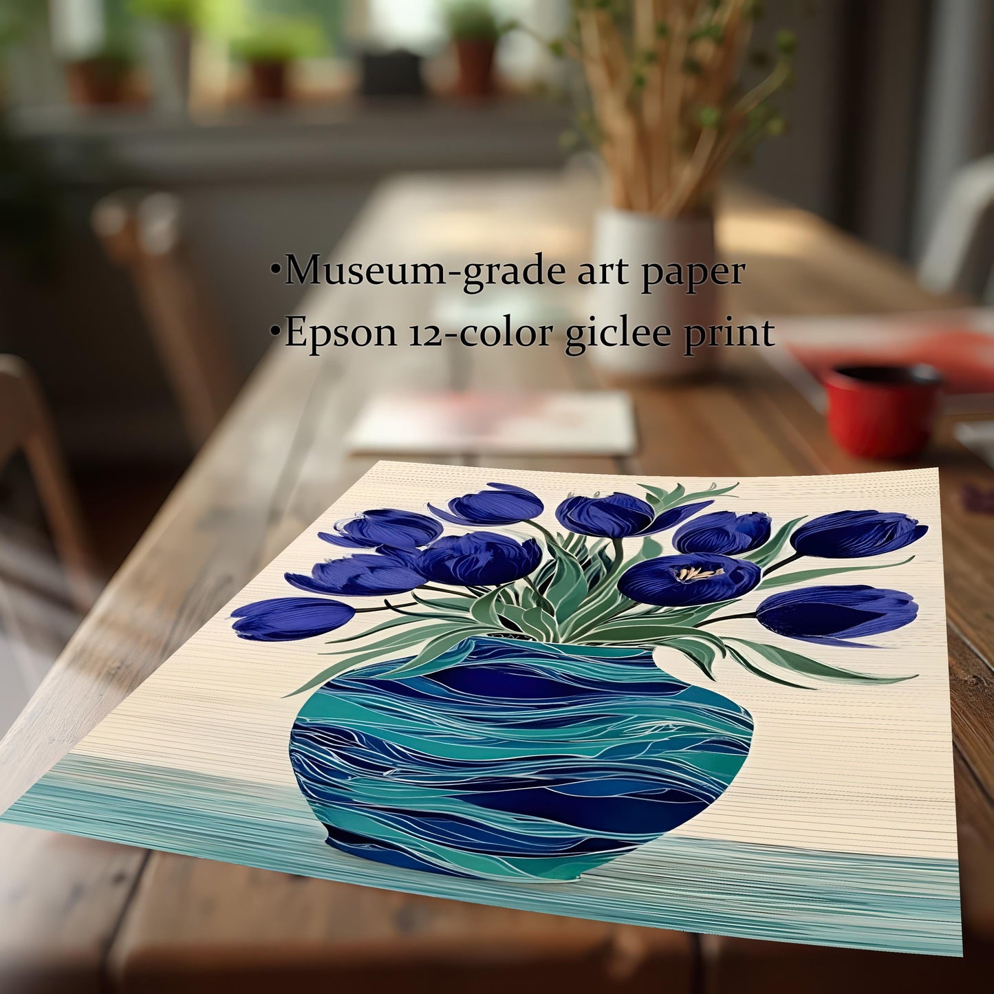 Close-up view of the unframed print of blue tulips and a turquoise vase resting on a wooden table, emphasizing the print quality. Text notes Museum-grade art paper and Epson 12-color giclee print.