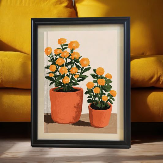 Black framed art print of two orange potted flowers, leaning on the floor against a bright yellow couch