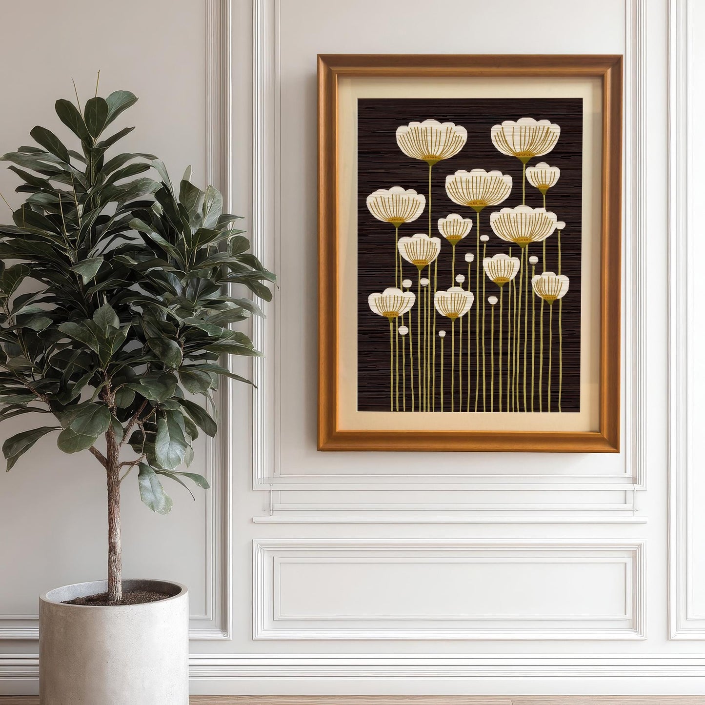 Orange framed art print of abstract white and gold flowers, hanging on a white paneled wall next to a large potted plant.
