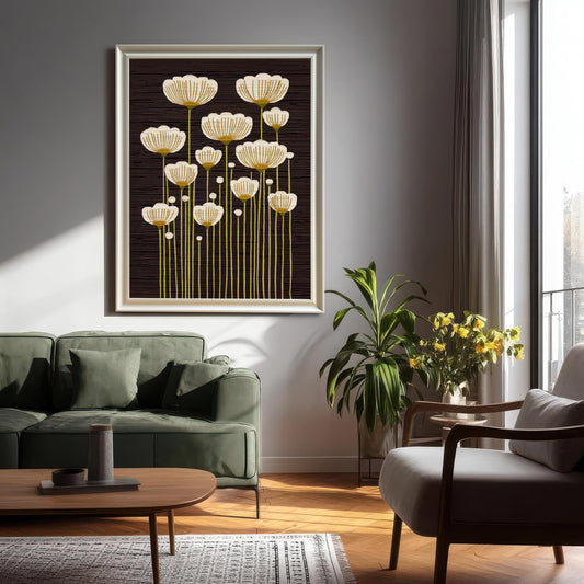 Large White framed art print of abstract white and gold flowers on a dark background, hanging on a gray wall above a green sofa in a modern living room.