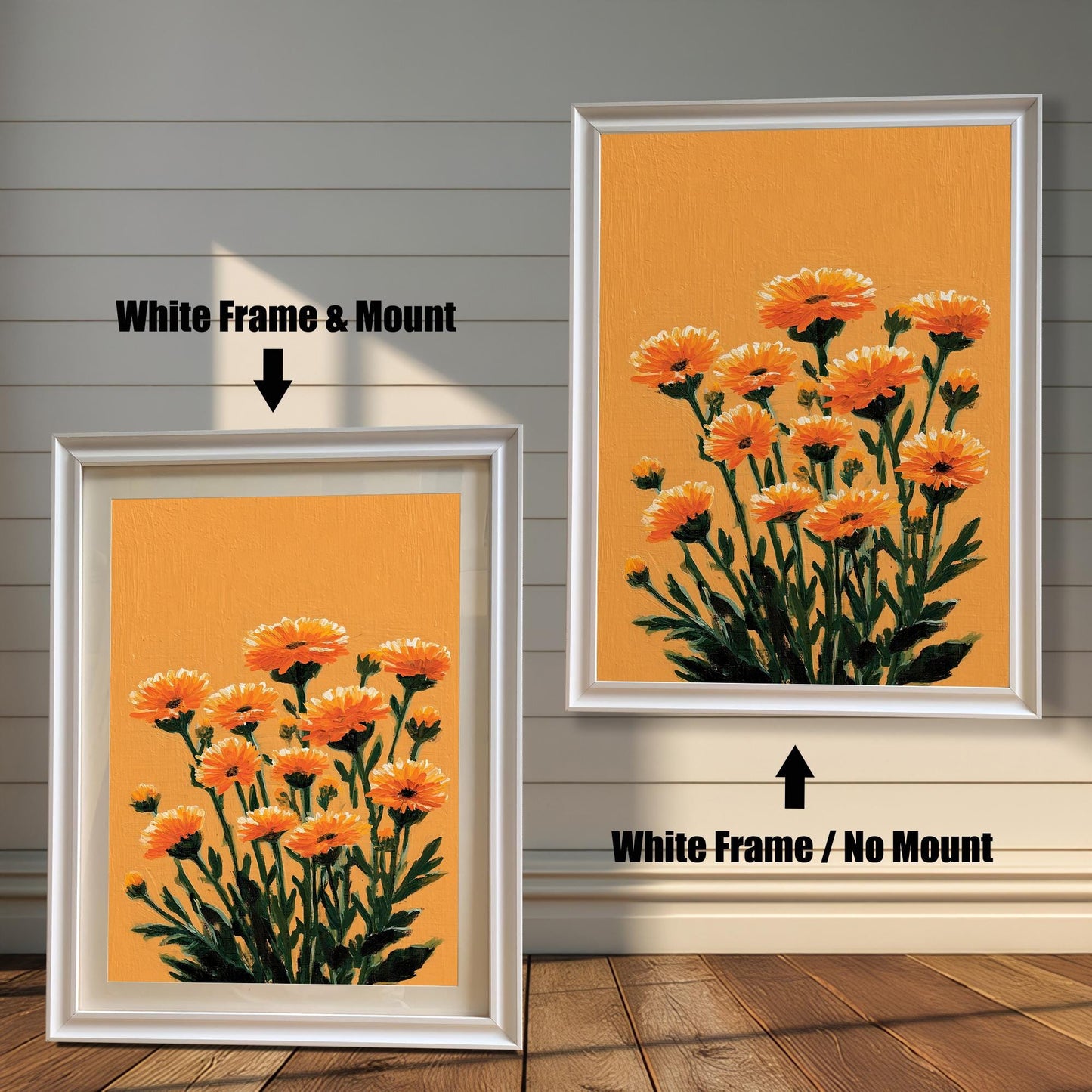 Two framed orange floral art prints against a white wood panel wall and wood floor. The print on the left has a White Frame & Mount (matting). The print on the right has a White Frame / No Mount.