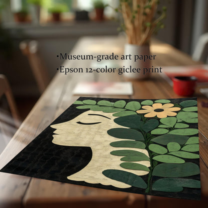 Close-up of an unframed botanical profile art print on a wooden dining table. The image shows a side profile of a woman's face surrounded by green leaves and a yellow flower on a black background. Text highlights Museum-grade art paper and Epson 12-color giclée print.