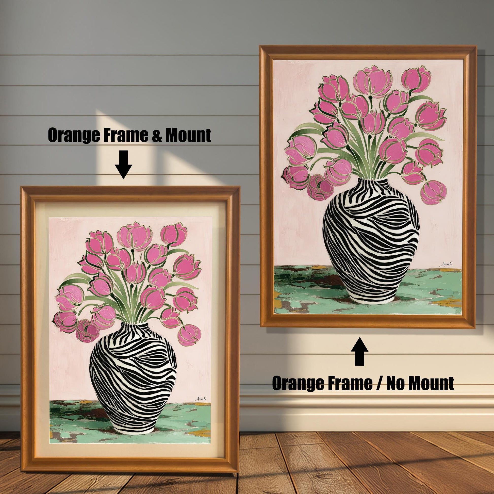 Zebra Vase and Pink Tulips art print shown in two orange wood frames on a rustic wood panel wall. The left frame includes a mount/mat, and the right frame shows the print without a mount/mat.