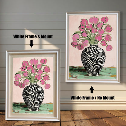 Zebra Vase and Pink Tulips art print shown in two white wood frames on a rustic wood panel wall. The left frame includes a mount/mat, and the right frame shows the print without a mount/mat.