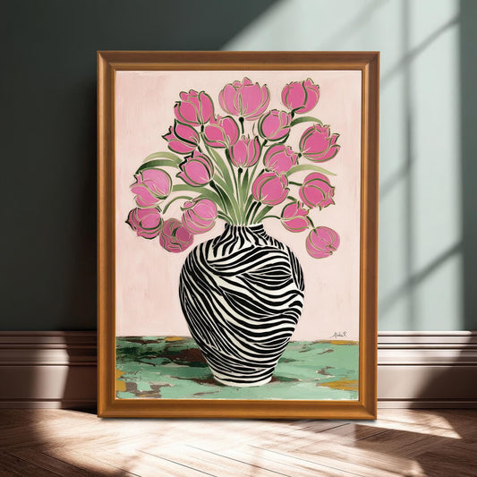 Framed print of an abstract painting featuring pink tulips in a black and white zebra striped vase, set against a pink background, shown in a gold/orange frame leaning on the floor with sunlight shadows.