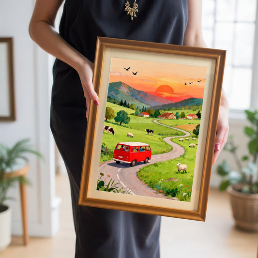 A person in a black dress holds the small framed print of the red van countryside scene, showcasing the artwork's scale and the warm Orange/Gold frame color.