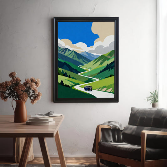 A framed print of a blue van on a winding road through lush green mountains and a bright blue sky. The print is in a Black Frame and hangs on a white textured wall in a modern interior setting.