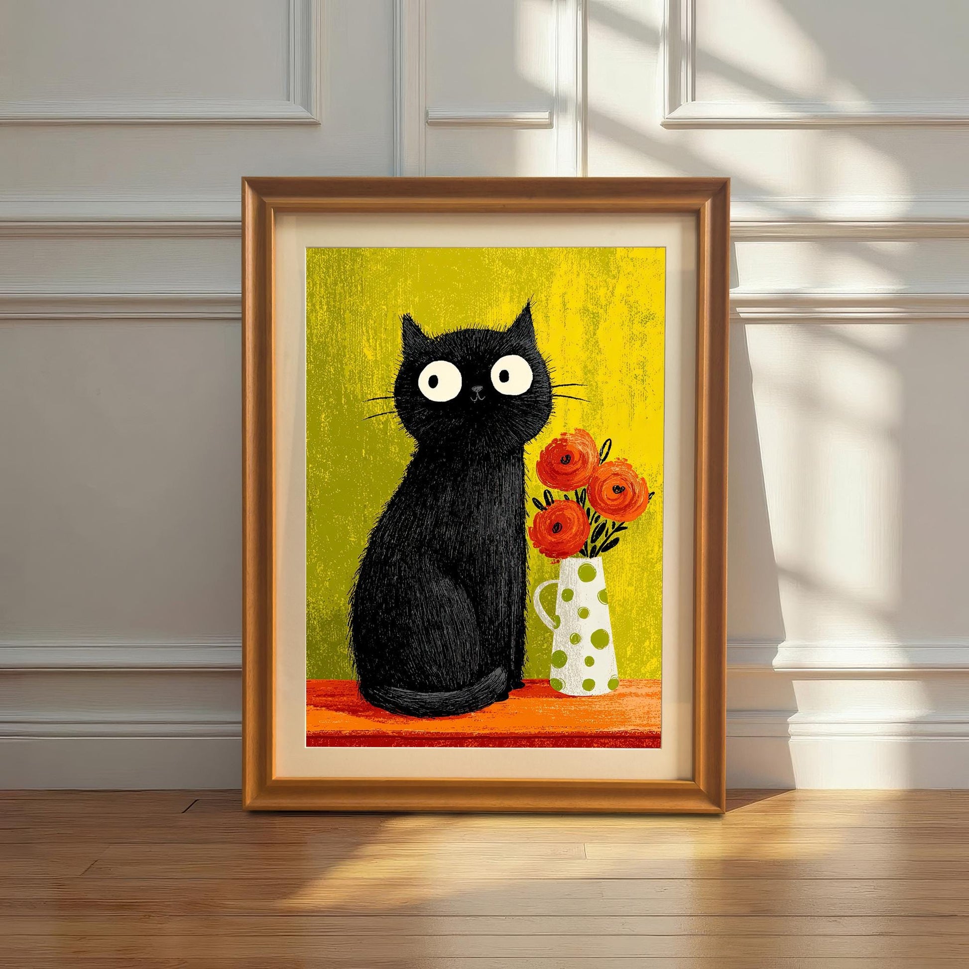 Vertical framed art print of a whimsical black cat and orange flowers against a lime-green background, displayed in an Orange/Gold wood frame with a mount/mat. The print is leaning on a hardwood floor against a white paneled wall with a plant in a white vase on the side.