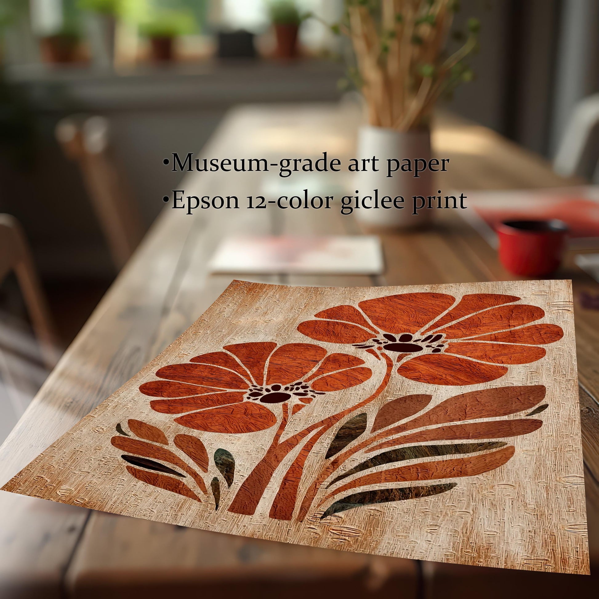 Close-up of the orange flower art print lying on a wooden table, highlighting its texture and color. Text overlay says: ""Museum-grade art paper"" and ""Epson 12-color giclee print"".