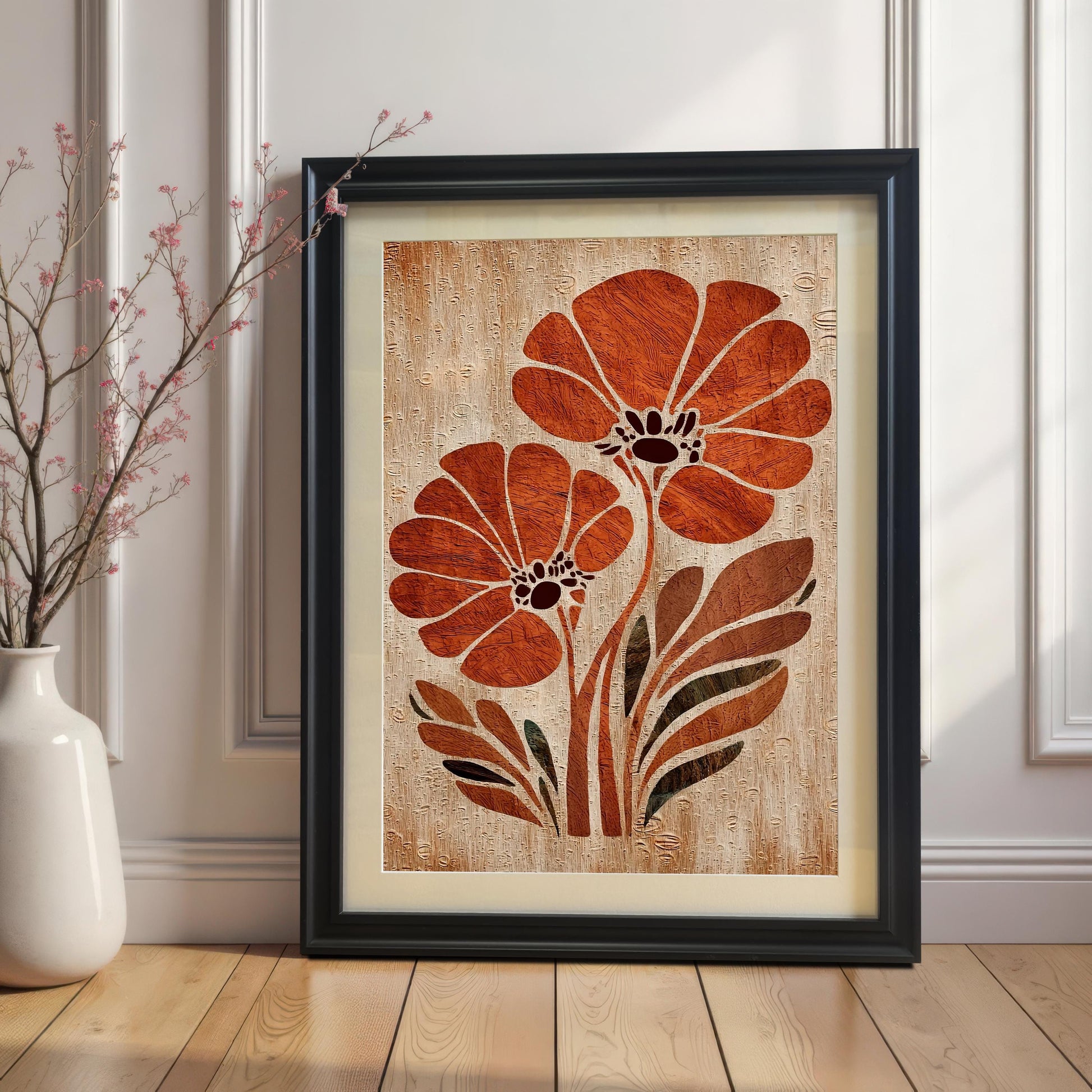 Orange flower abstract art print in a Black Wood Frame with a white mat/mount. The framed art is propped against a classic white wainscoting wall on a wooden floor next to a white vase with small pink branches.