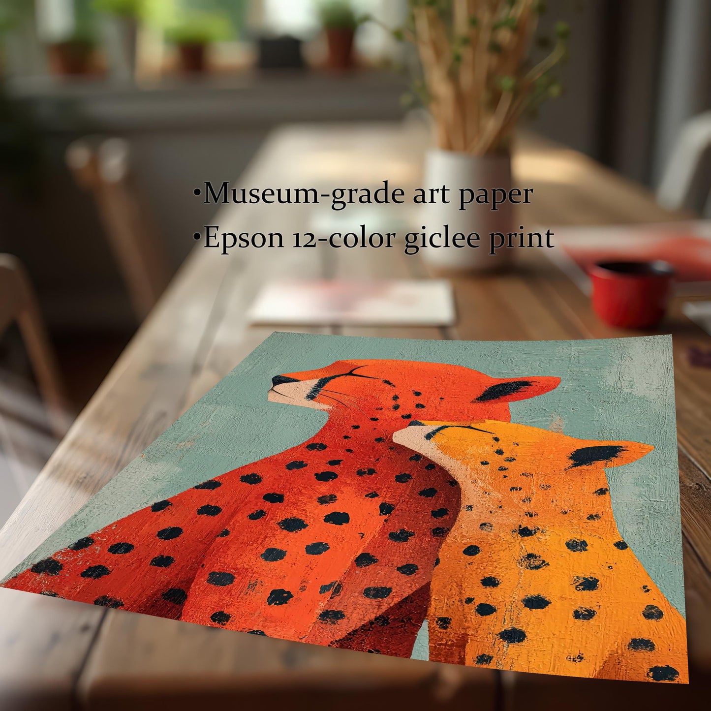Close-up of an unframed print of the 'Cheetah Love' artwork resting on a wooden table. Text describes the print quality: Museum-grade art paper, Epson 12-color giclee print.