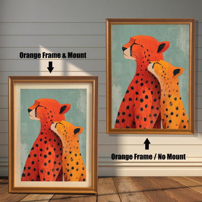 Two framed versions of the 'Cheetah Love' print against a white wooden wall. On the left is the Orange Frame with a light mount/matting. On the right is the Orange Frame without a mount.
