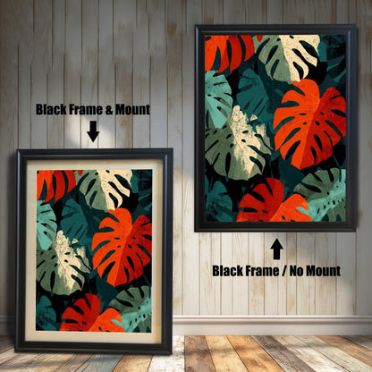 Close-up view of a framed art print featuring a repeating pattern of bold, stylized Monstera leaves in deep red, teal, cream, and dark green. The image shows two frame options: a Black wood frame with a mount (matting) and a Black wood frame with no mount around the print.