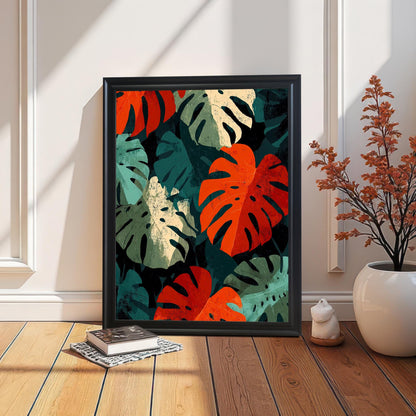 Lifestyle shot of the vibrant Monstera leaf art print with a Black wood frame, leaning on a light-colored wood floor against a white paneled wall. Natural sunlight creates bright highlights and shadows. A book is stacked on the floor, and an orange-leafed plant in a white pot is on the right.