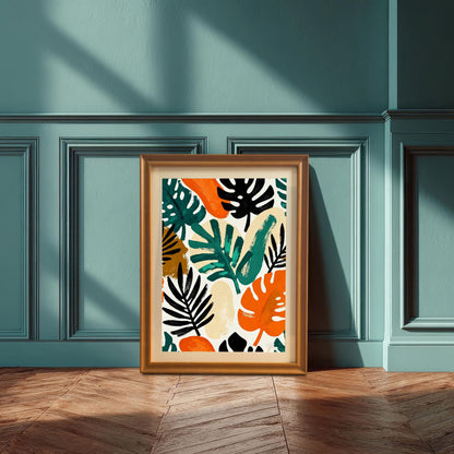 A framed art print with a colorful abstract tropical leaf pattern, leaning against a dark teal, paneled wall with strong window shadows. The print features bright orange, various shades of green, black, and beige, in a gold/orange wood frame.
