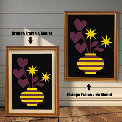 Comparison image showing a golden-brown Orange framed art print with a light-colored mount (mat) on the left, and an Orange framed art print without a mount on the right. Both prints feature a purple and yellow striped vase with purple heart-shaped leaves and yellow star flowers on a black background.