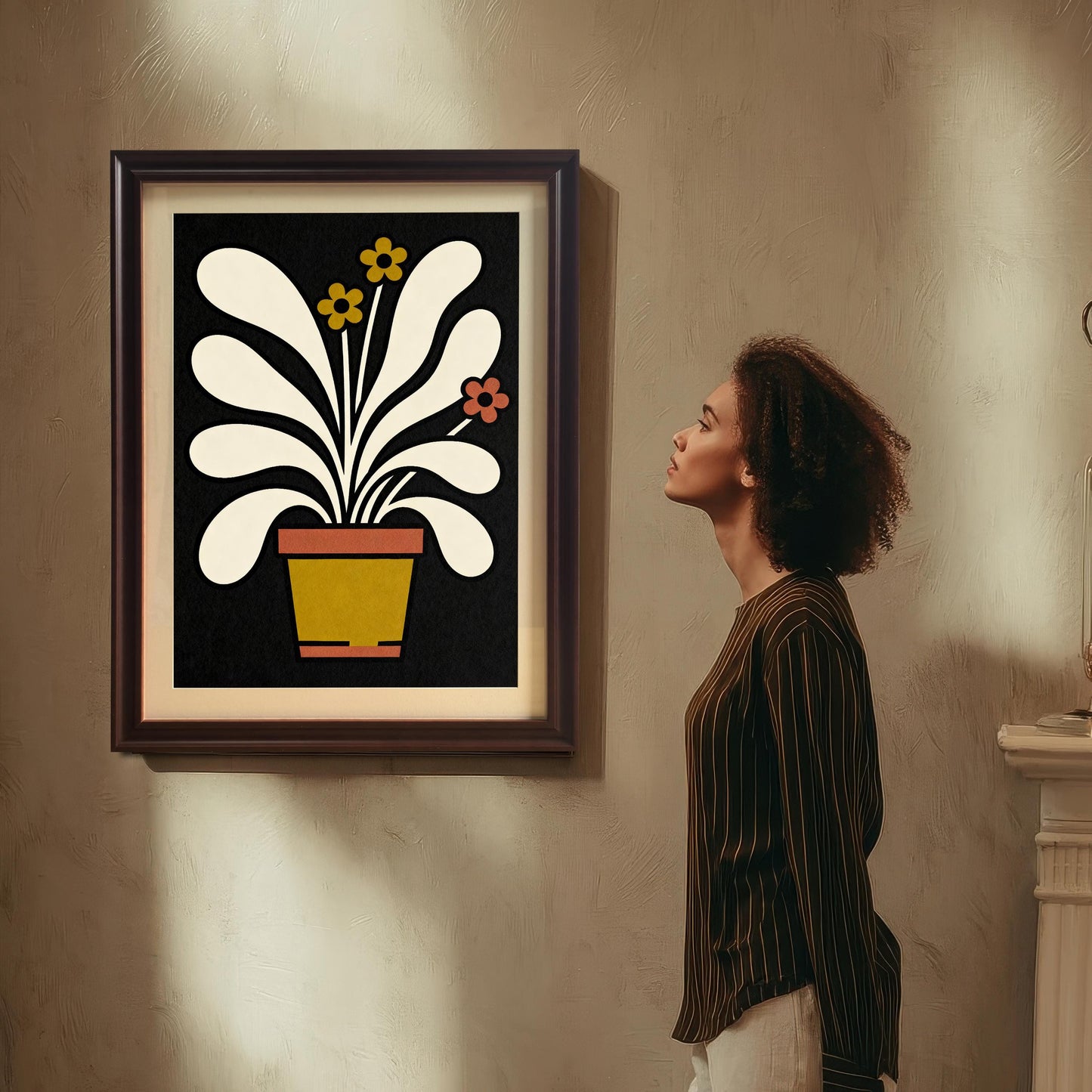 Mock-up of the abstract potted plant art print in a Coffee-colored (dark brown) wood frame, hanging on a textured wall. A woman in a striped shirt stands beside it, looking up at the artwork.