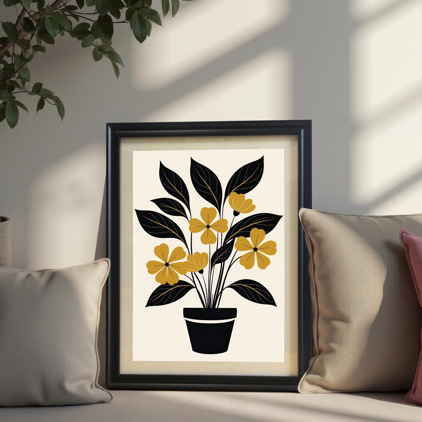 Mock-up of the abstract yellow and black potted plant art print displayed in a Black frame, propped up on a couch or windowsill between two throw pillows, with a potted plant and sunlight shadows above.