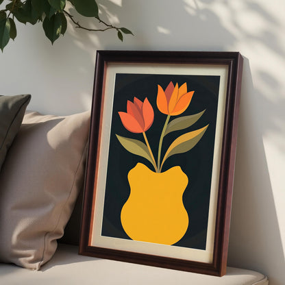 Coffee-colored framed art print with a light mount, featuring two orange and red tulips in a yellow vase. The print is leaning against a wall on an upholstered bench next to two pillows.