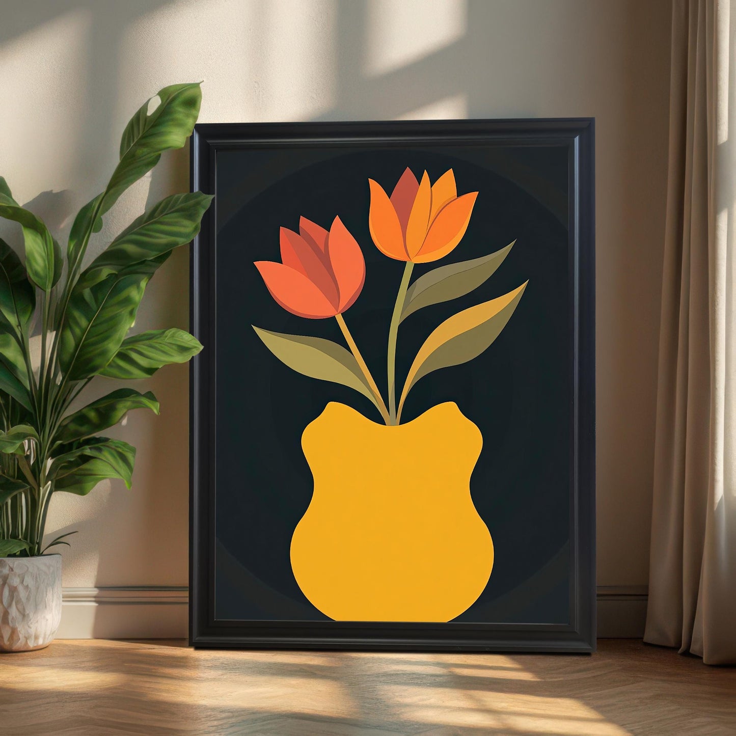 Black framed art print featuring two orange and red tulips in a curved yellow vase, with a plant in a white pot on the left. The print is leaning on a wood floor in a sunlit room.