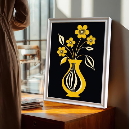 White-framed yellow flower and vase print leaning on a wooden table near a window, with a person standing nearby.