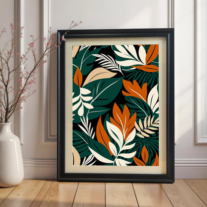 Styled image of the Black framed abstract tropical leaf art print with a mount/mat, propped against a white panelled wall and wooden floor. A tall white vase with pink-flowered branches is next to the frame.