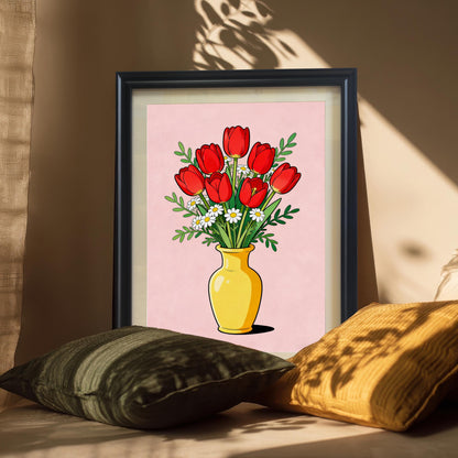 Framed print of the red tulips and daisies in a Black frame, leaning against a neutral-colored wall and propped up by decorative pillows. Sunlight casts a shadow pattern across the wall and image.