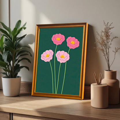 The pink floral art print in an Orange Frame (no mount), propped up on a wooden desk next to a potted houseplant and decorative vases.