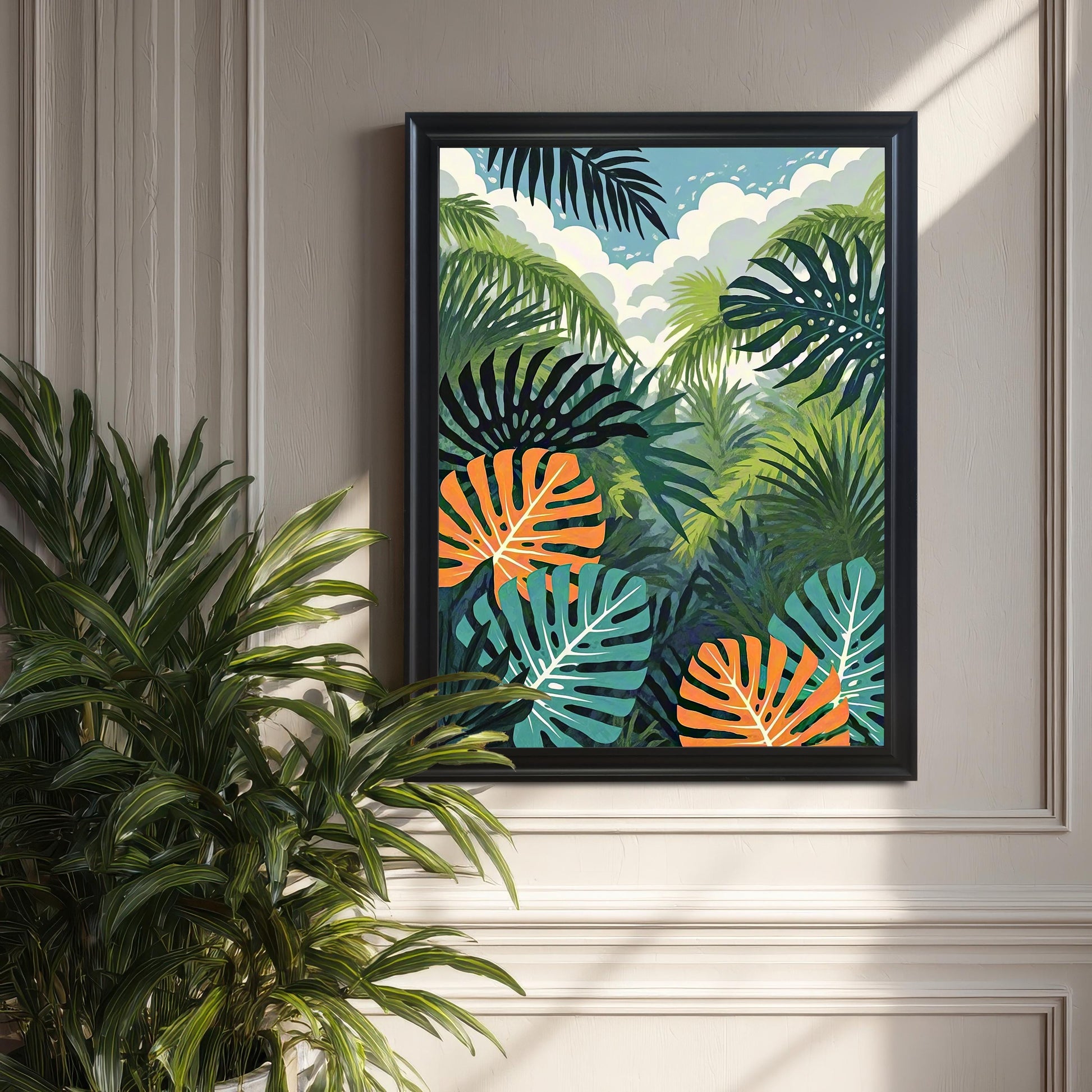 The tropical jungle art print in a black frame, hung on a light grey paneled wall, next to a large, real houseplant (likely a parlor palm or similar). Natural sunlight casts strong shadows across the wall.