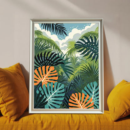 A tropical jungle art print in a White Frame, resting on a textured gold or mustard-yellow pillow, surrounded by two matching pillows. The artwork features vibrant green, dark teal, and bright orange monstera and palm leaves under a blue sky.