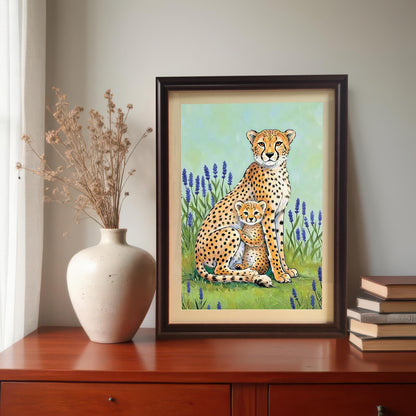 A lifestyle image of the framed art print of a cheetah mother and cub in a field of lavender. The print is in a Coffee Wood (dark brown) frame with a mount and is displayed on a dark wood dresser next to a cream vase of dried flowers and a stack of books.