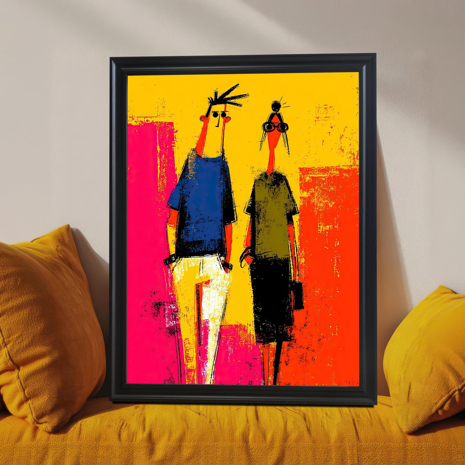 Vibrant abstract print of two stylized figures framed in a Black Frame without a mount. The framed art is resting on a yellow upholstered couch or bench between two large yellow throw pillows.