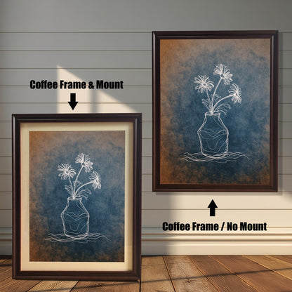 Comparison image showing two dark brown framed art prints. The left print is a Coffee Frame & Mount (with a mat board), and the right print is a Coffee Frame / No Mount. The art is a white chalk-style flower drawing on a blue and rust-colored textured background.