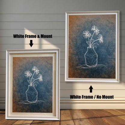 Comparison image showing two white framed art prints. The left print is a White Frame & Mount (with a mat board), and the right print is a White Frame / No Mount. The art is a white chalk-style flower drawing on a blue and orange textured background.