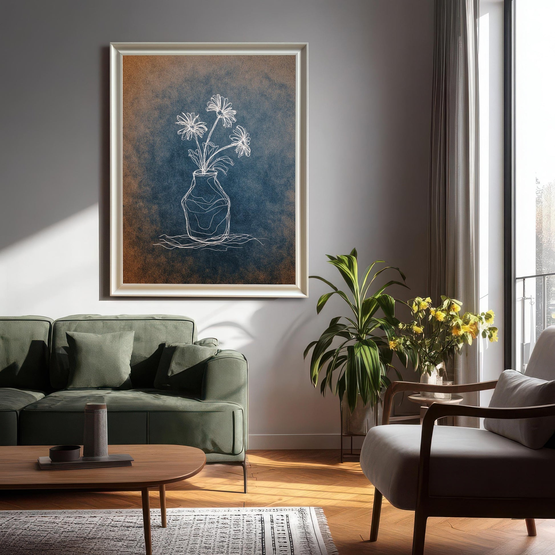Large framed chalk flower print in a light/silver frame hanging above a dark green sofa in a modern living room. The artwork features a white line drawing on a distressed blue and orange background.